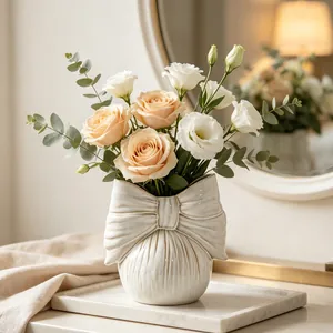 Detailed shot of cream ceramic bow-knot vase with ribbed texture in home setting