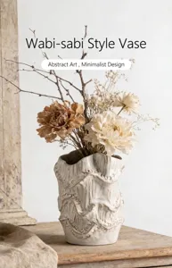 Detailed view of handmade vintage ceramic vase featuring abstract wavy textures and dried flowers