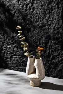 Artistic U-shaped ceramic vase featuring a textured surface in antique white glaze
