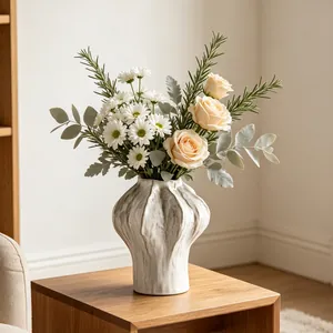 Minimalist white ceramic vase with organic wavy texture in a cozy home setting