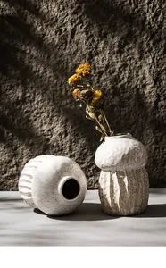 Detailed view of wabi-sabi mushroom ceramic vase with textured surface and dried flowers