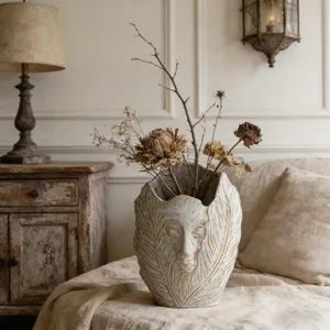 Close-up of Nordic abstract face ceramic vase with leaf texture in a vintage setting