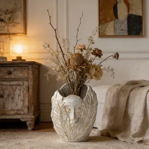 Artistic ceramic vase with abstract face and feather texture in vintage interior setting