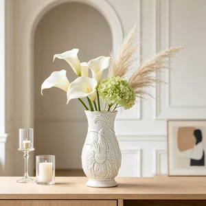 Detailed view of an ornate French style white ceramic vase with floral relief