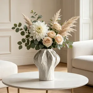 Elegant detail view of a textured white ceramic vase with fresh flower arrangement