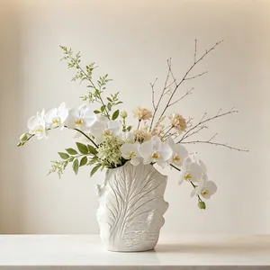 Detailed view of wabi-sabi ceramic vase with leaf vein texture in a lifestyle setting