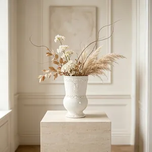 Detail shot of a French vintage white ceramic vase featuring intricate relief patterns