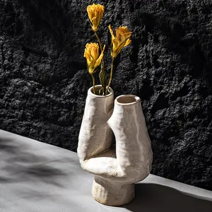 Elegant white sculptural ceramic vase with organic shape for artistic home decor