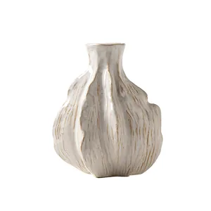 Elegant modern minimalist white ceramic vase featuring a creative organic garlic shape