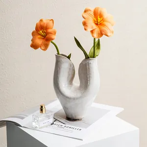 Artistic minimalist white ceramic vase with U-shape design for modern Nordic home decor