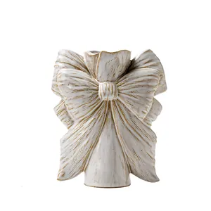 Elegant white bow-shaped ceramic vase with vintage gold trim for chic home decoration
