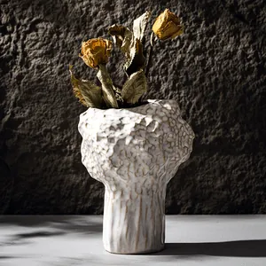 Elegant Nordic cream ceramic vase with bumpy texture and dried roses for home decor