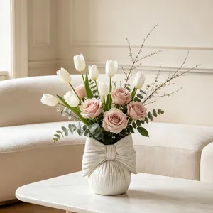 Elegant cream ceramic bow vase with vertical texture detail for minimalist home decor
