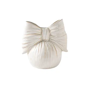 Elegant minimalist white ceramic bow-shaped flower vase for artistic home decoration