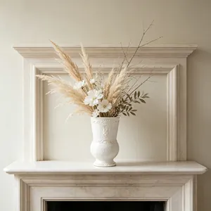 Close-up of white French vintage ceramic vase with bunny relief on a marble mantel