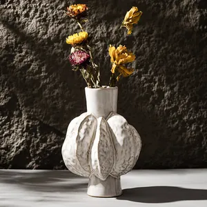 Artistic off-white ceramic vase with textured pod design, perfect for dried flower arrangements