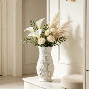 Detail view of an elegant French-style white ceramic vase with relief patterns.