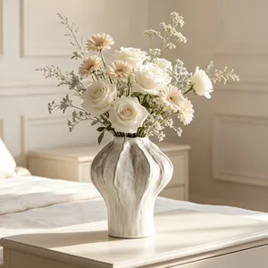 Elegant white ceramic vase with textured ripples shown in a cozy lifestyle bedroom setting