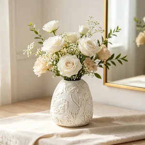 Detailed view of an embossed ceramic vase with delicate floral patterns for home decor.