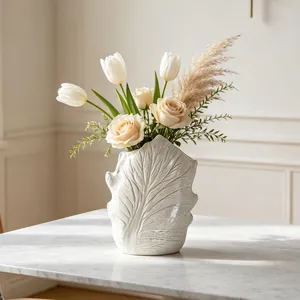 Detailed view of wabi-sabi ceramic vase with leaf-vein texture on a marble table