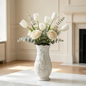 Detailed macro view of white embossed ceramic vase featuring elegant vintage floral relief patterns