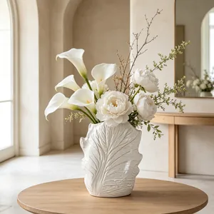 Close-up of white ceramic vase with natural leaf vein texture in wabi-sabi style
