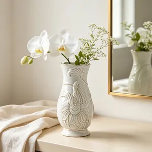 Detail showing elegant embossed floral patterns on a vintage French ceramic vase