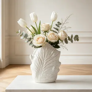Detail showing the intricate leaf vein texture on a minimalist white ceramic flower vase