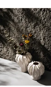 Detailed view of two minimalist white textured ceramic vases for artistic home decoration