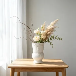 Close-up of a white ceramic vase with French vintage relief and rabbit motif on wood table