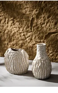 Macro detail of textured white ceramic vases on minimalist neutral background