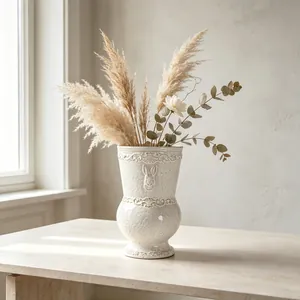 Close-up detail of a vintage French white ceramic vase with rabbit relief motif decor