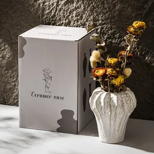 Elegant white textured ceramic vase with dried flowers and premium packaging box