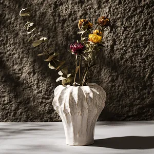 Minimalist white ceramic vase with organic wrinkled texture for home decor.