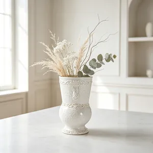 Close-up of white French relief ceramic vase with rabbit engraving on a marble table