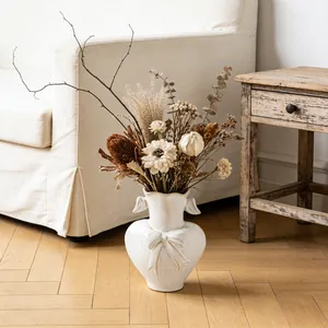 Elegant white heart-shaped ceramic vase with artistic dried flower arrangement set
