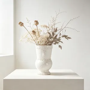 Elegant vintage white ceramic vase with rabbit relief detail and dried floral display