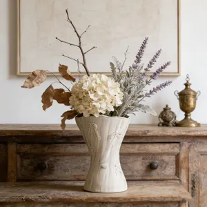 Minimalist white ceramic vase with a textured bow pattern, ideal for modern home decor