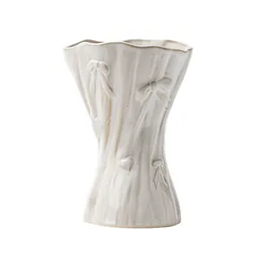 Minimalist white ceramic vase with relief bow and wavy rim