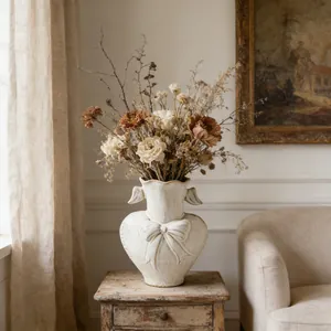Vintage-style white ceramic heart-shaped vase with bow relief for dried flowers