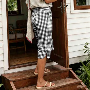 Retro black and white gingham capri pants for women with side buttons and side slit detail