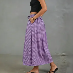 Side view of a purple gingham high-waisted midi skirt with pockets and A-line silhouette