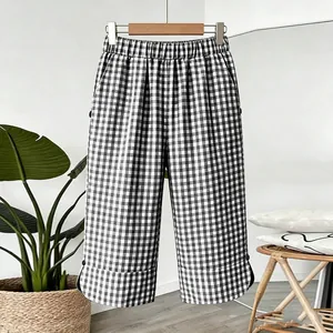 Vintage black and white checkered wide-leg shorts with elastic waist and button detail