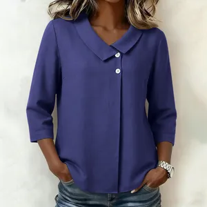 Blouse décontractée en lin bleu avec col en V, manches 3/4 et coupe ample boutonnée.