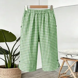 Detail of green and white gingham cropped pants with a comfortable elastic waistband