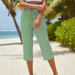 Close-up of green and white striped cropped pants featuring a drawstring waist and side slits