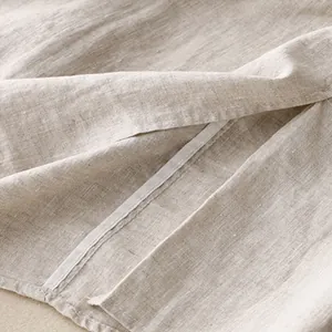 Close-up detail of beige cotton linen skirt showing fabric texture and seam reinforcement