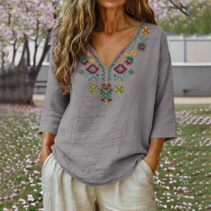 Close-up detail of retro embroidered gray cotton linen top with V-neck and 3/4 sleeves