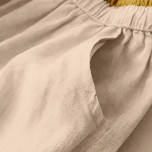 Detailed macro shot of a linen skirt featuring a side pocket and elastic high waist.