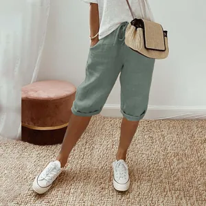 Detail of women's sage green cotton linen cropped pants with drawstring and pockets.